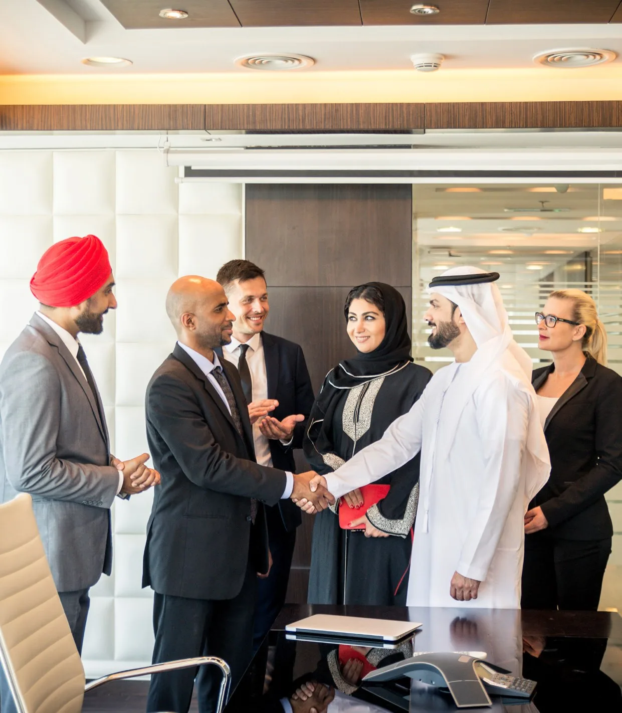 Elite Marcom team members greeting clients in a Riyadh office