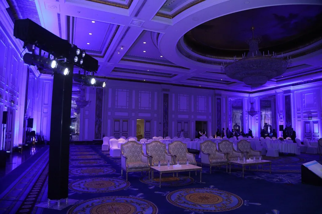 Ballroom event staged with dramatic violet lighting